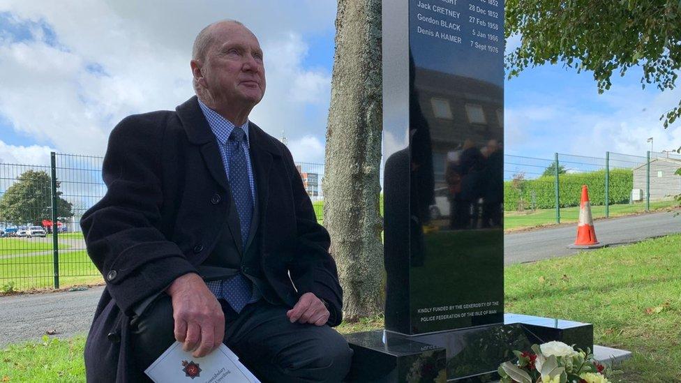 Alan Cretney next to the memorial