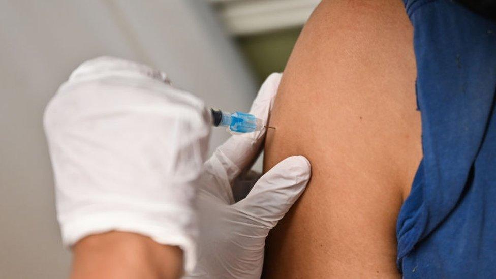 A woman receives a vaccination