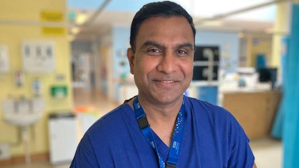 Ashok Subramanian in blue scrubs