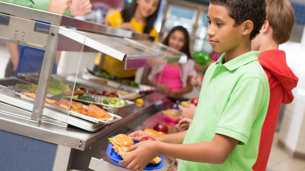 children getting school meals