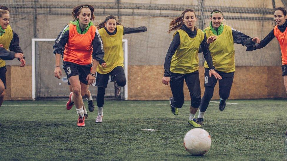 Girls playing football