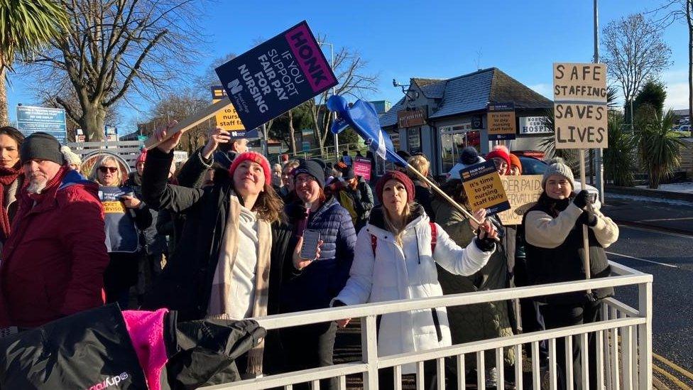 Nurses holding up signs on the picket line at Northern General Hospital