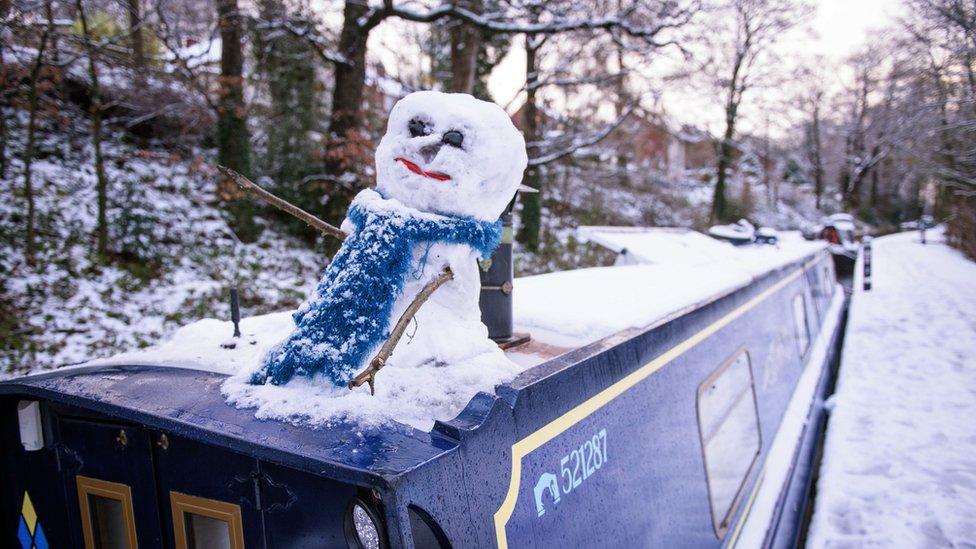 A snowman on top of a barge