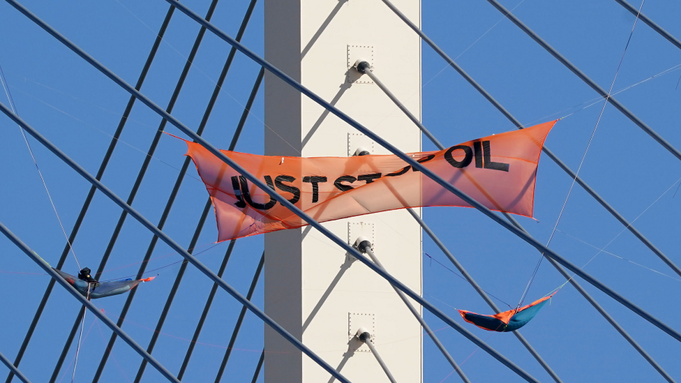 A Just Stop Oil banner hangs on the QEII Bridge between Kent and Essex