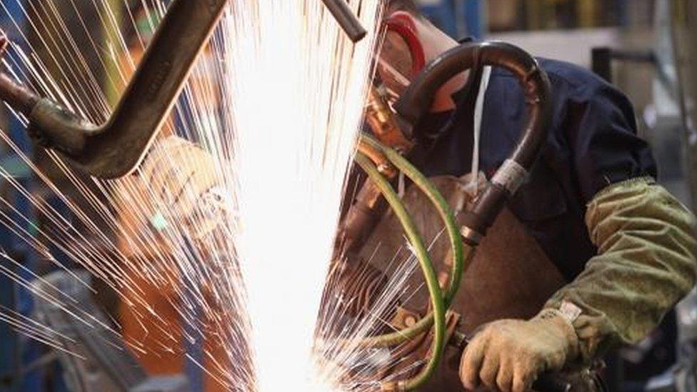 A technician spot welds a body panel of a Nissan car on the production line at Nissan's Sunderland plant