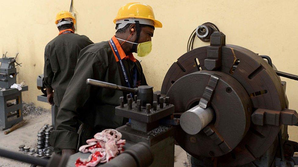 Indian manufacturing worker at a lathe