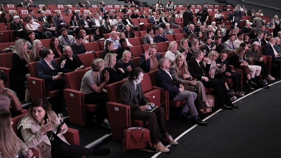 People seated at a business conference