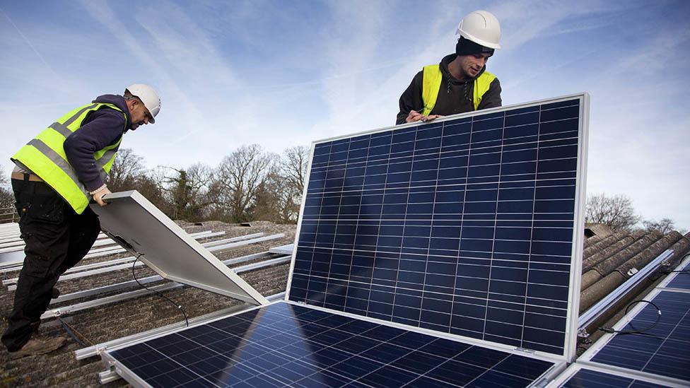 Fitters installing solar panels on a roof