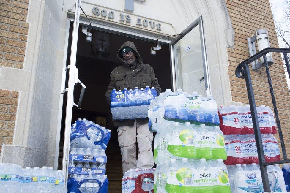 Man stacking water