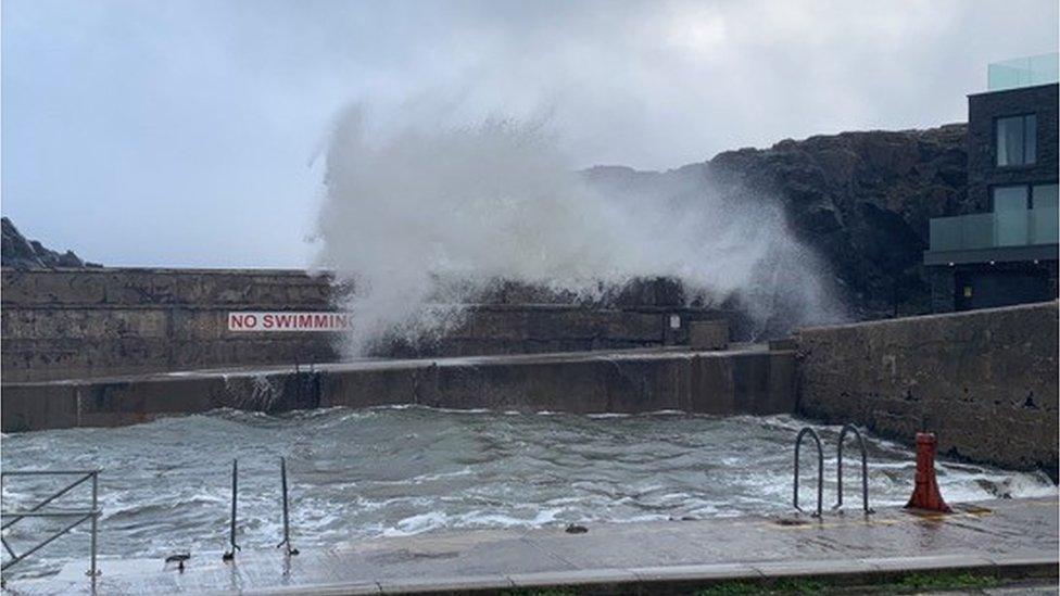 waves breaking over tidal pool at port stewart