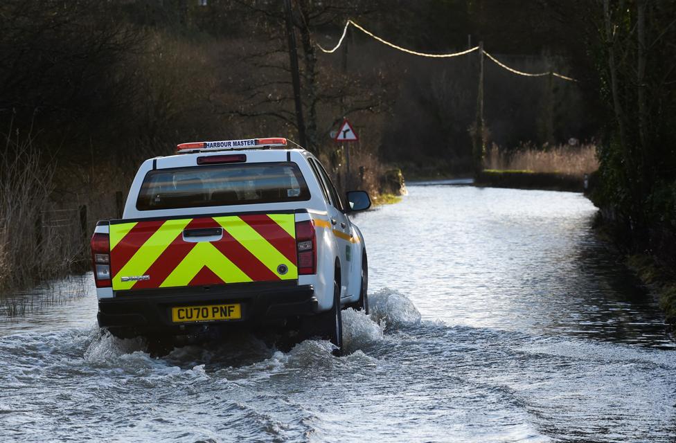 A truck drives through a flooded road in Tenby, 21 January 2021