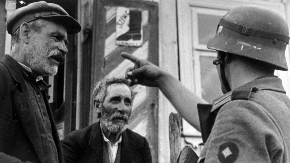 Photograph of Lithuanian Jews and a German Wehrmacht Soldier during the Holocaust in Lithuania in 1941