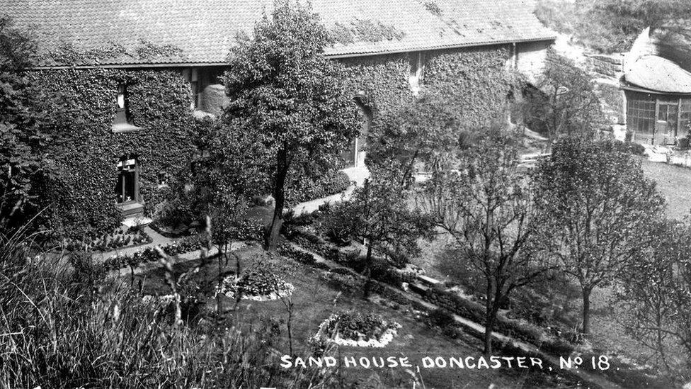 The front of Doncaster Sand House, with sunken garden