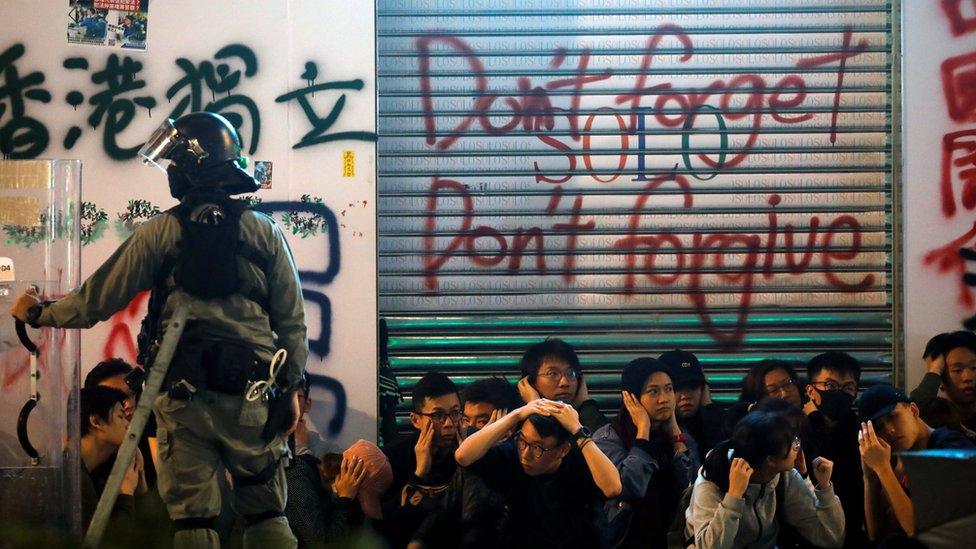 Anti-government protesters sit after being detained during a demonstration on New Year's Day to call for better governance and democratic reforms in Hong Kong, January 1, 2020.