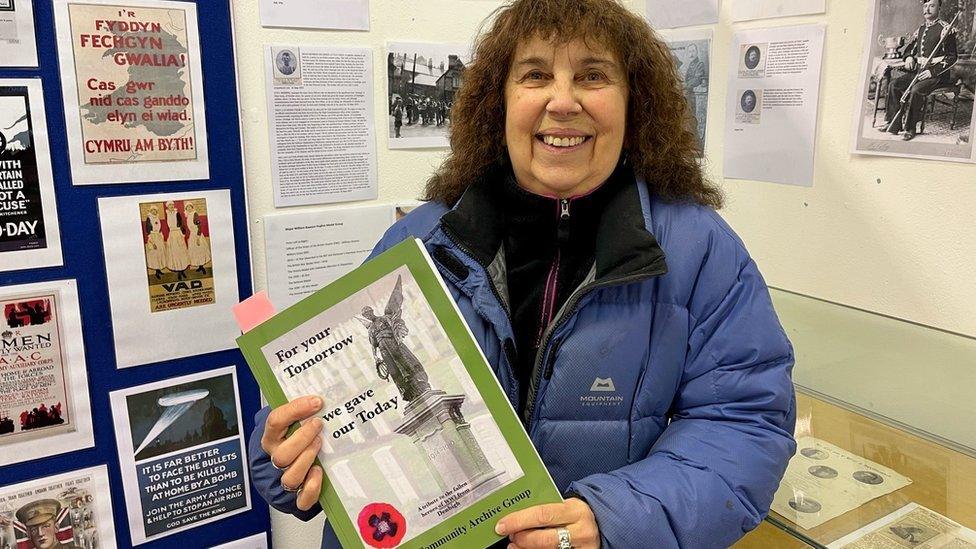 Ennis Davies holding the book