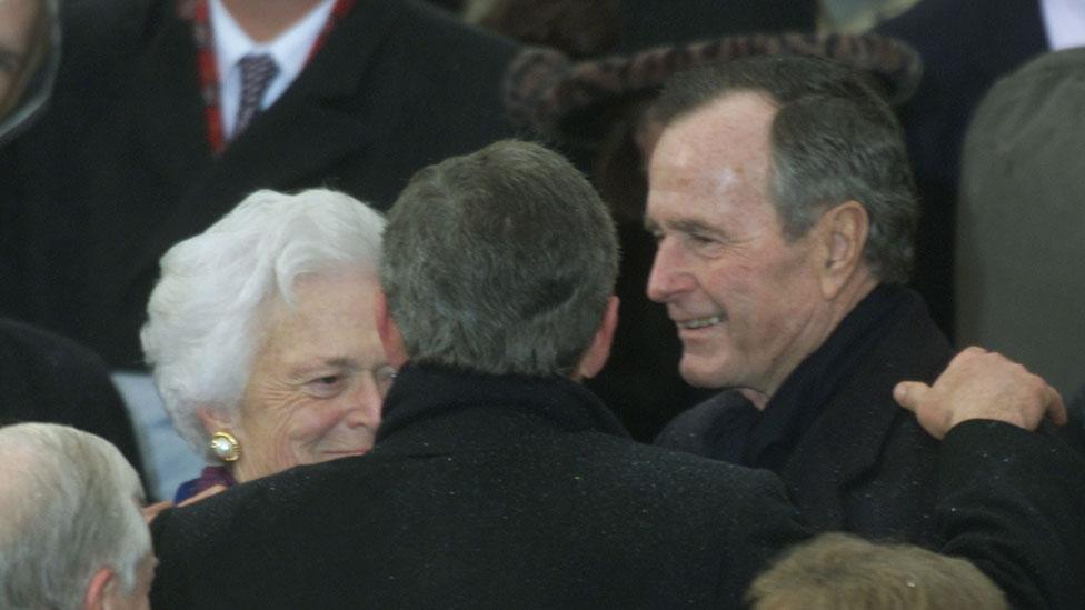 George W Bush embraces his parents following his inauguration