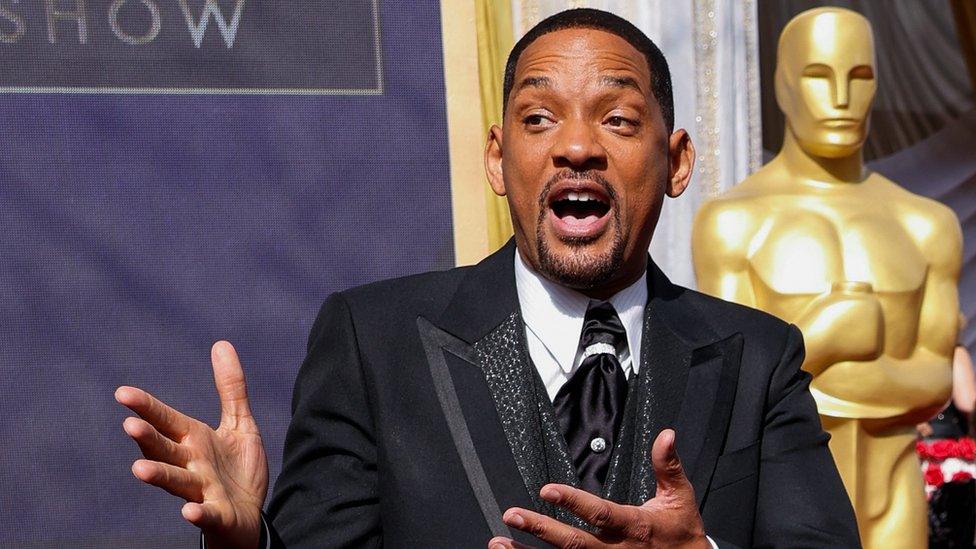 Will Smith in front of a giant Oscars statuette before the ceremony