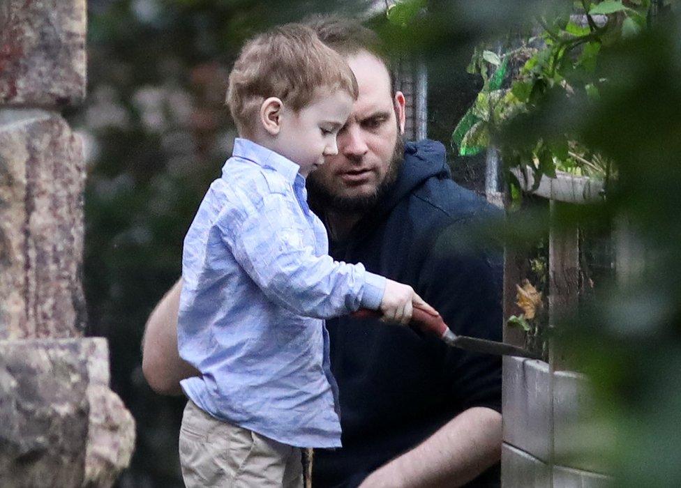 boyle plays with his son after their release