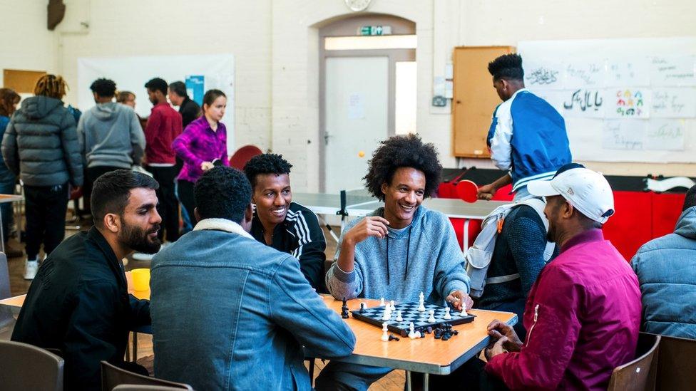 Refugees sat around a table