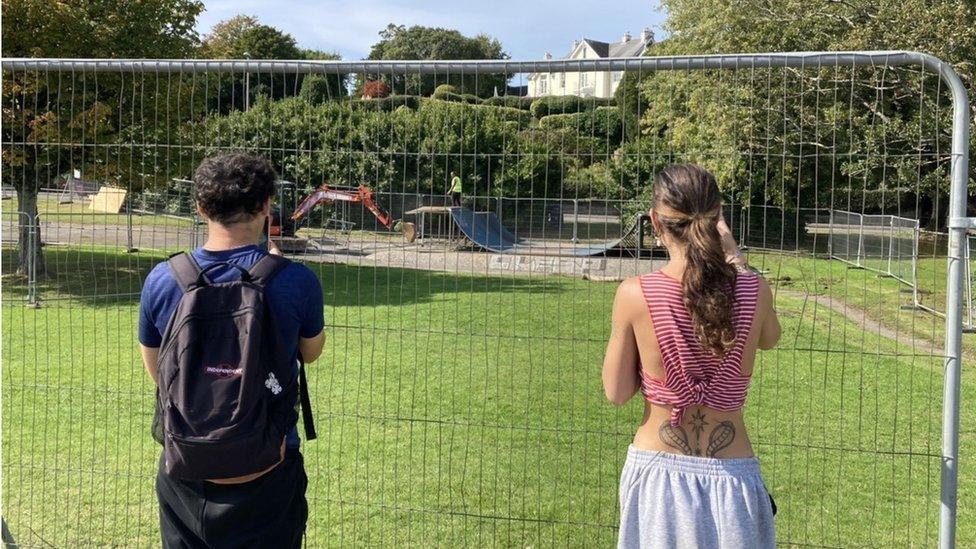 Young people watch as the work gets under way