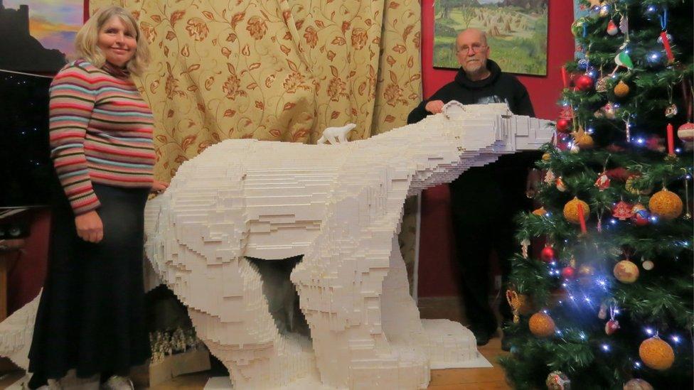 Mike Addis and his wife with their model polar bear.