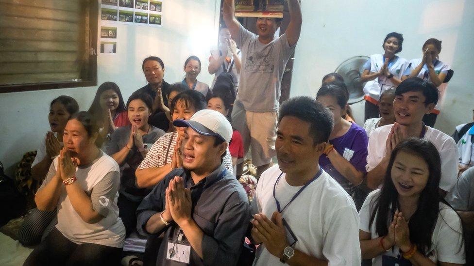 Relatives of the missing boys pray for them after the 12 boys and their soccer coach have been found alive