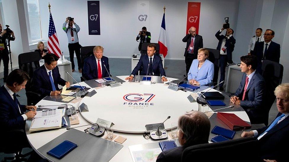 Leaders gather around a table at the G7 summit in France in 2019