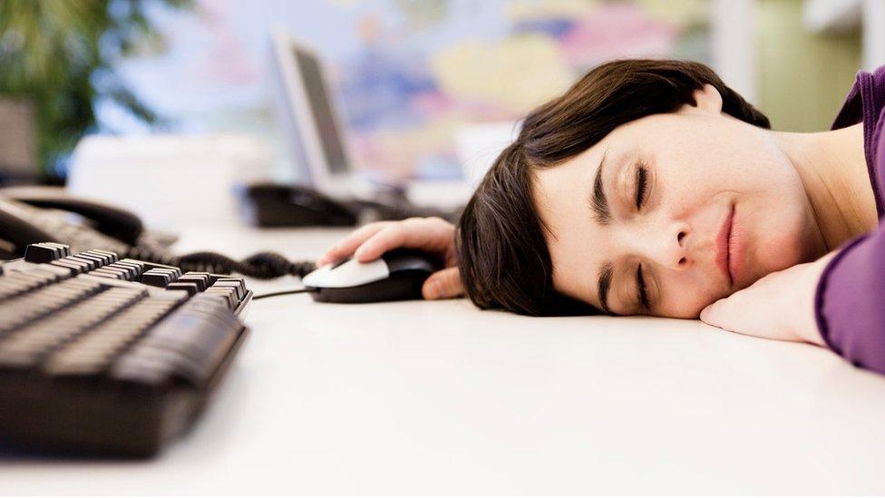 Woman lying on her desk