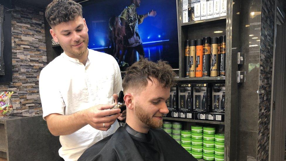 Holden Nicholson having a haircut