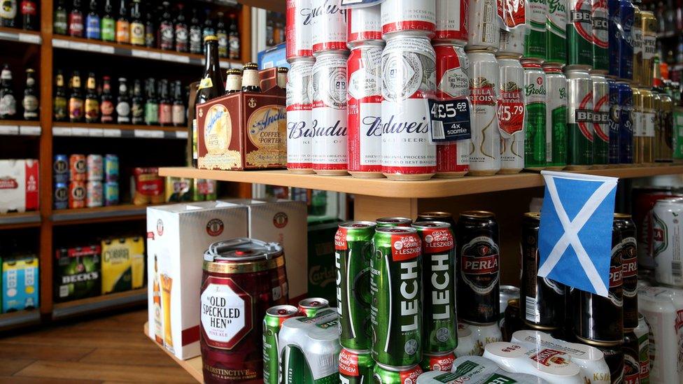 Cans of beer stacked up in an off licence