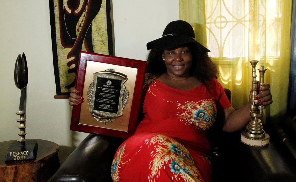 Burkina Faso film director Apolline Woye Traore holds her 3 prizes received for her last movie "Frontiere" during the Panafrican Film and Television Festival (FESPACO).