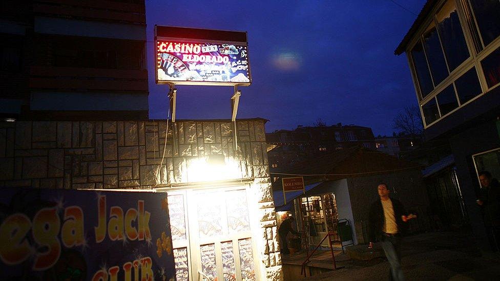 A sign for a casino is illuminated in Mitrovica, Kosovo, in 2007