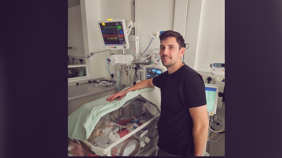 Jack next to Clara's NICU cot