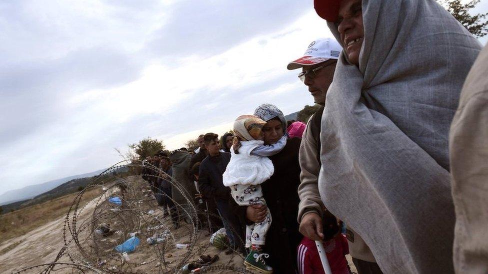 Refugees and migrants wait to pass the borders from the northern Greek village of Idomeni to southern Macedonia