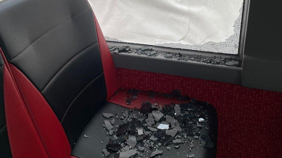 Smashed glass on bus seat