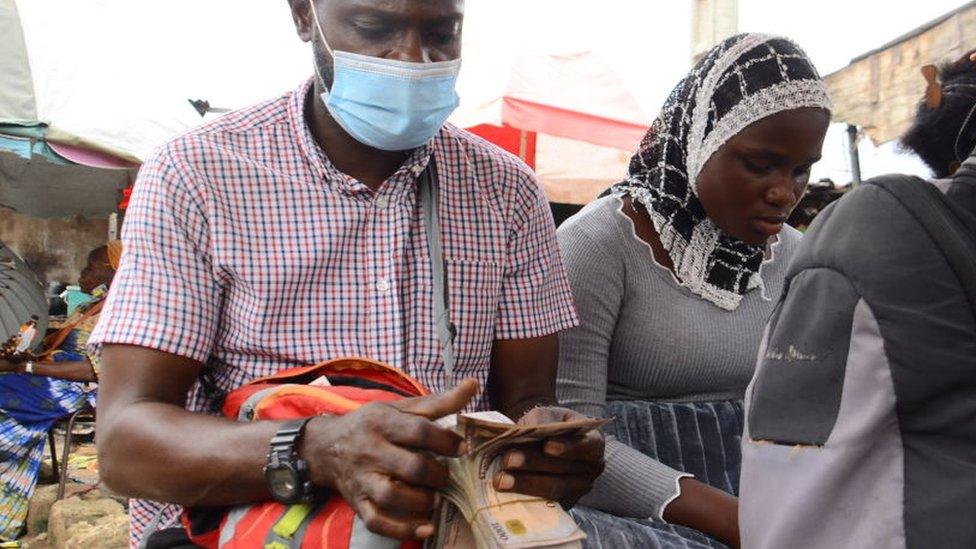 A man in Nigeria counting naira notes