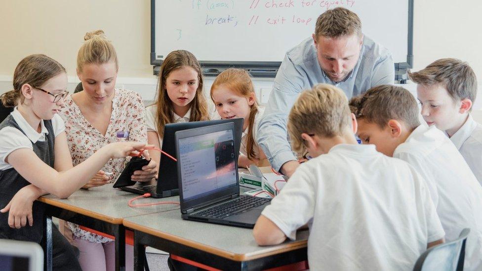 Teacher taking a lesson with laptops