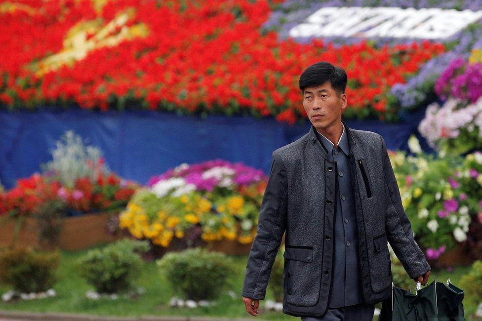 A man walks in front of decoration near the venue of a ruling party congress in Pyongyang, North Korea 6 May 2016