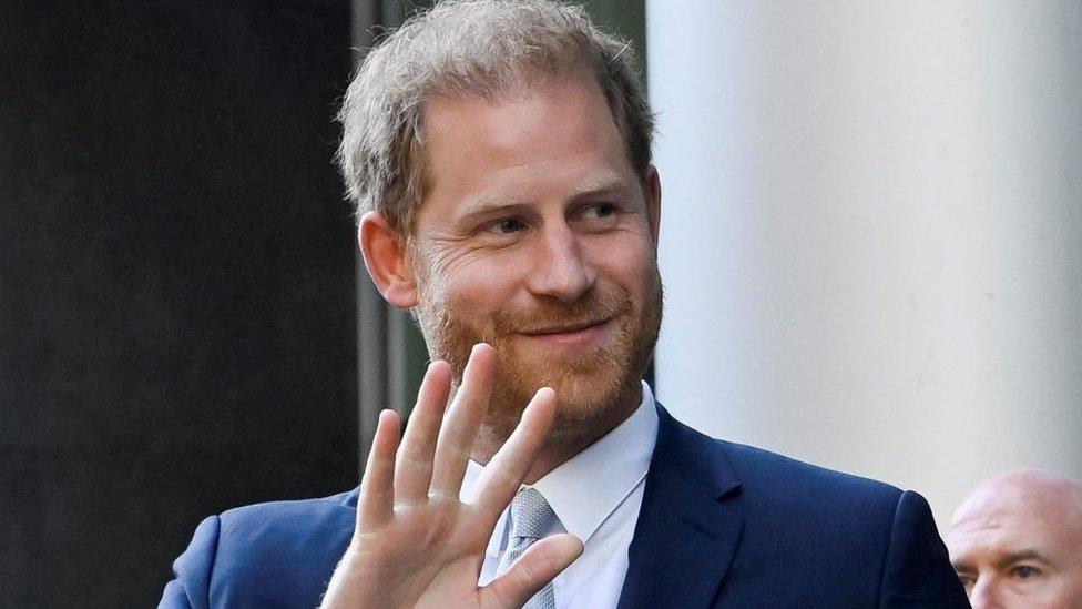 Prince Harry waving outside court