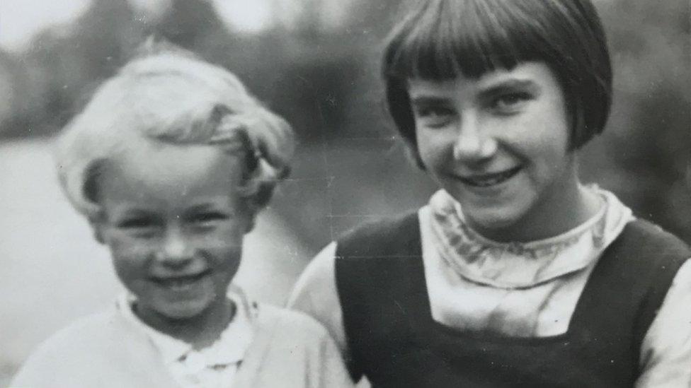 A black and white photo of two children