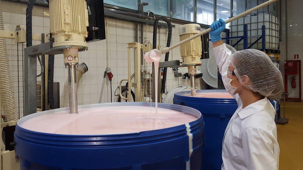 A Natura Siberica worker checking on shampoo being made