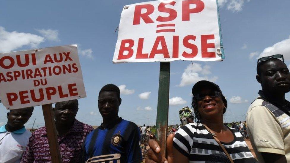 Protesters hold signs reading "Regiment of Presidential Security (RSP) = Blaise (Compaore)" and "Yes to the aspirations of the people" during a protest not far from the hotel where Ecowas leaders were holding a meeting in Ouagadougou on 23 September 2015