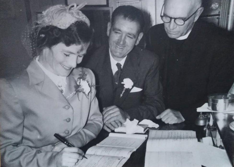 Bridget Dolan signing the marriage register on her wedding day