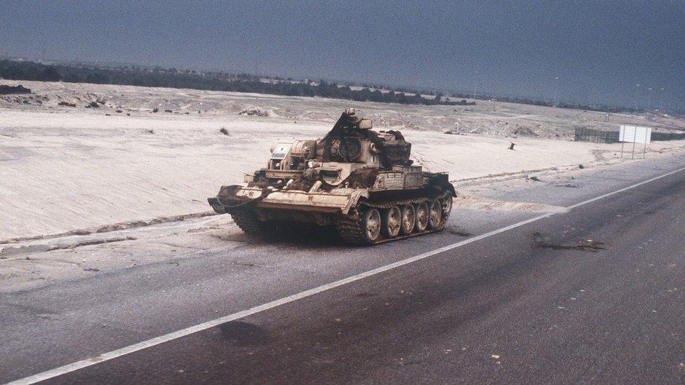 A Chinese-made Type 653 armoured recovery vehicle abandoned by Iraqi troops sits on the side of the road into Kuwait City during the ground phase of Operation DESERT STORM.