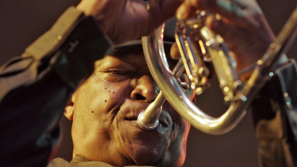 South African jazz maestro Hugh Masakela playing trumpet