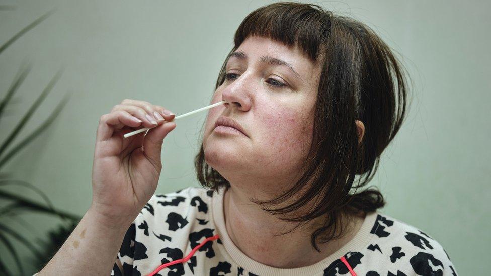 A woman taking a Covid test