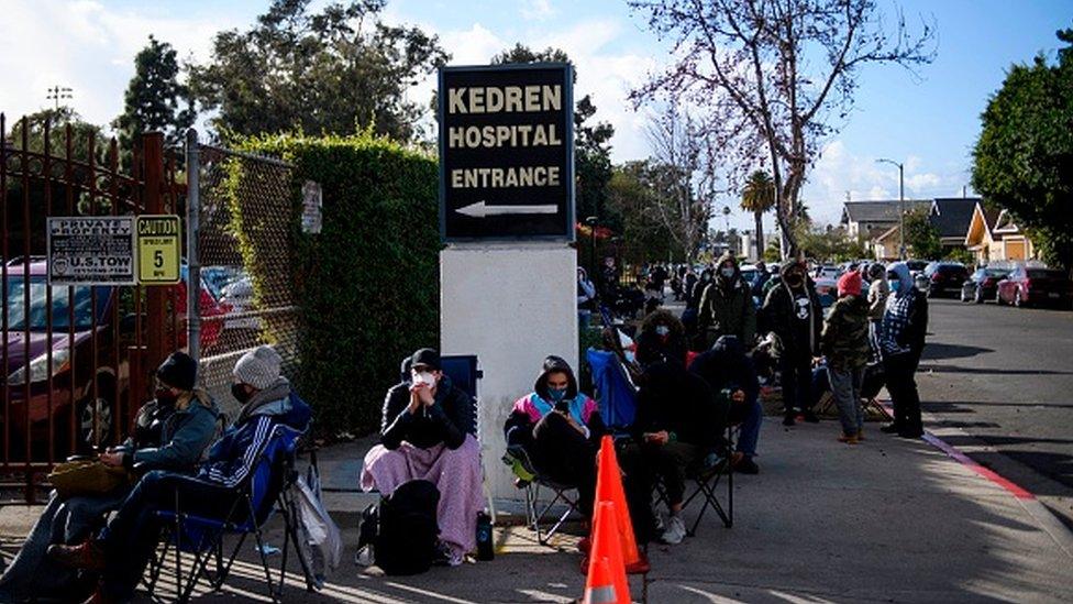 People wait in line for the potential chance to receive a Covid-19 vaccination in Los Angeles, California