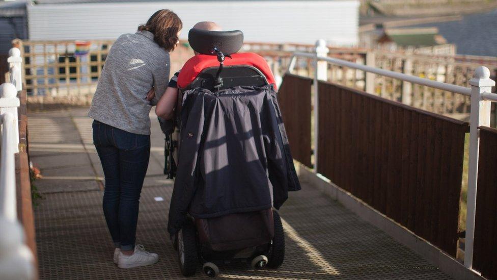 A person and a care worker in Southport