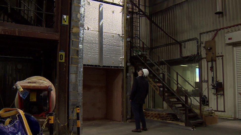 Fire test rig used at the BRE, with reporter for scale