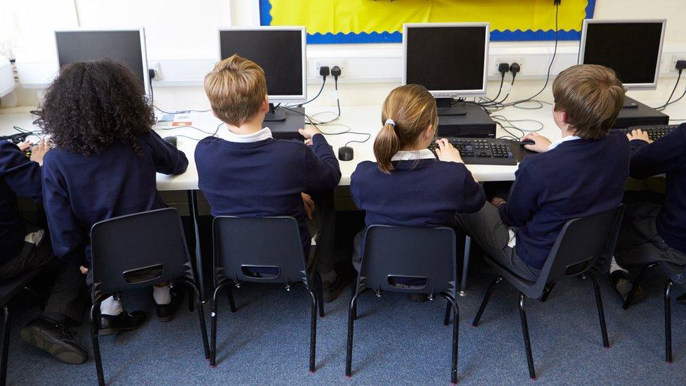 Children in school computer class